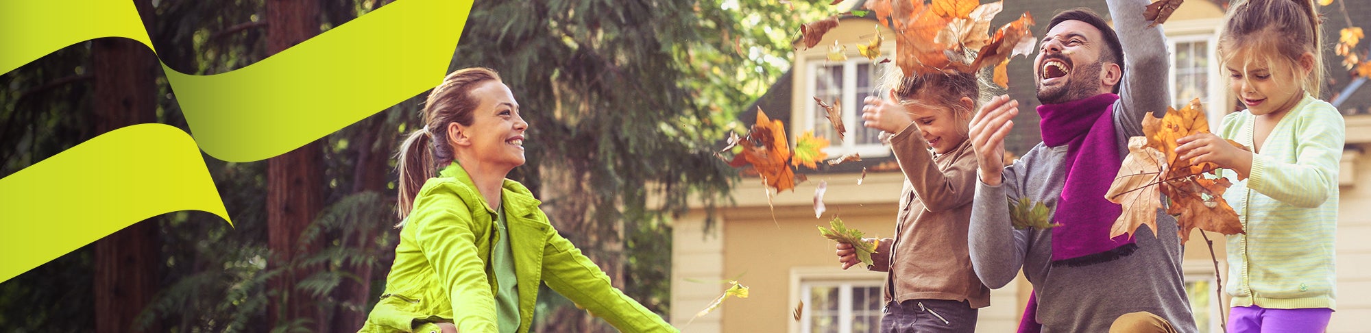 family playing outside in fall leaves