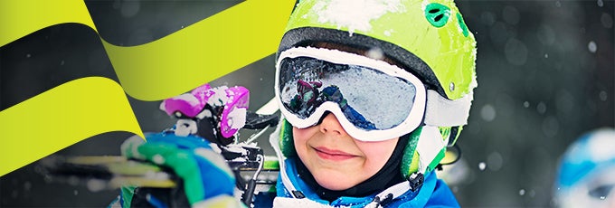 child carrying skiis