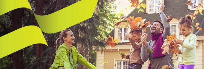 family playing outside in fall leaves