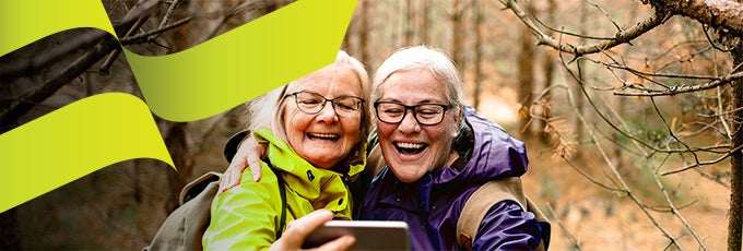 older mother and daughter taking a selfie