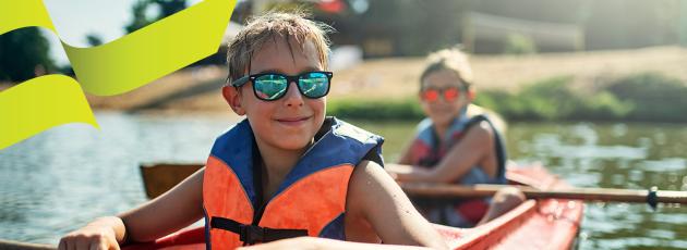 Two kids on a kayak with sunglasses - AU Mobile Summer Banner