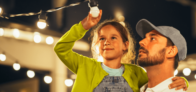 Father and daughter looking at lights