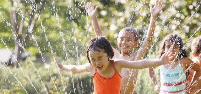 Kids running through sprinklers