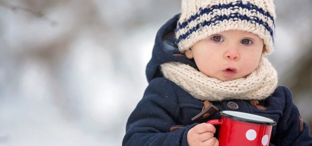 Kid in winter with a cup