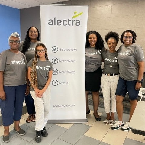 Group of women wearing Alectra shirts