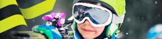 child carrying skiis