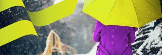 person walking in the snow with a purple coat and lime green umbrella