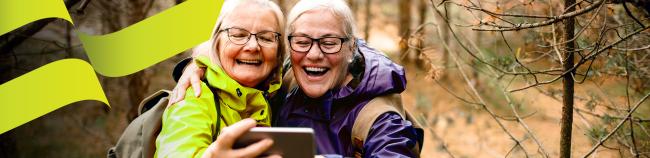 older mother and daughter taking a selfie