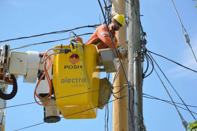 alectra repair man working on electricity pole