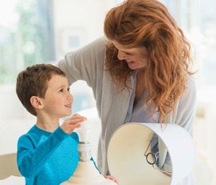 a mother and son replacing a lightbulb