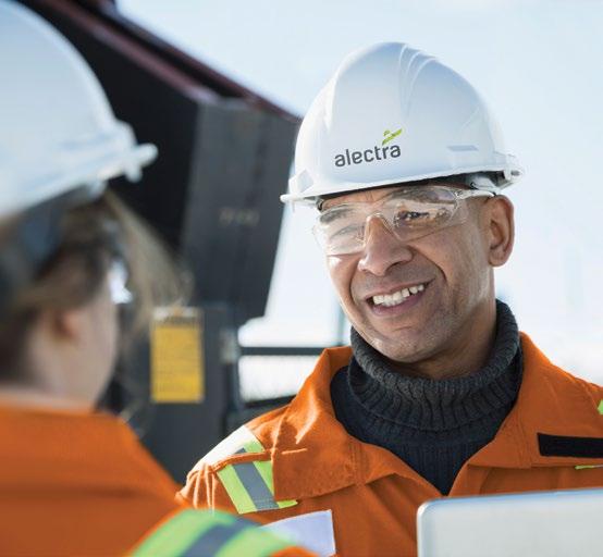 Alectra worker smiling and speaking to another worker