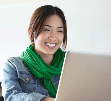 Woman smiling and looking at her computer